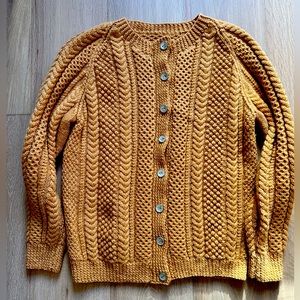 Hand knit cable cardigan.